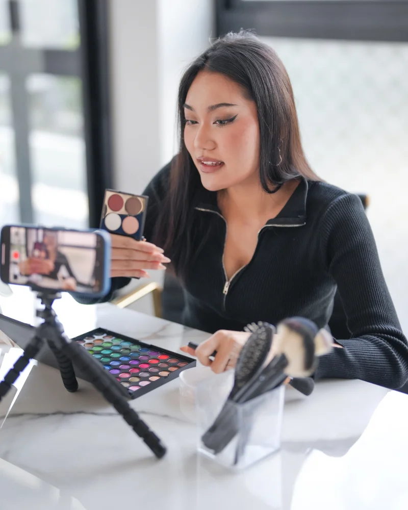 Professional makeup artist shooting video for her audience
