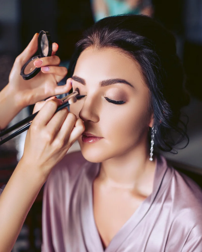 Professional make artist doing makeup for a client.