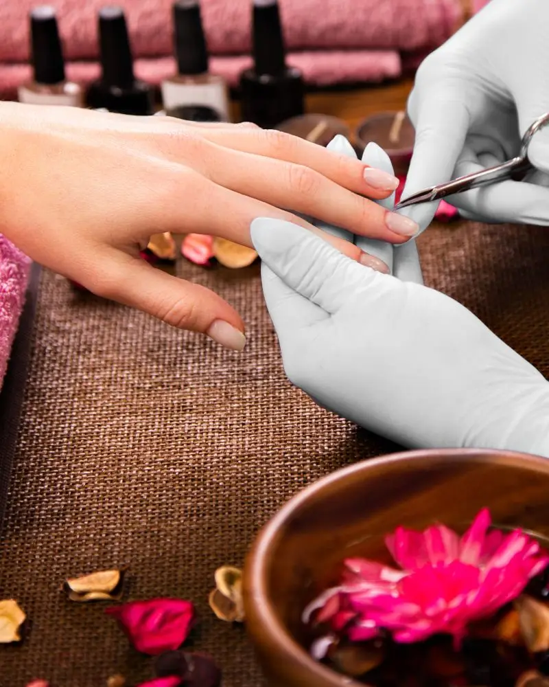 Close-up of a manicure specialist providing nail care.